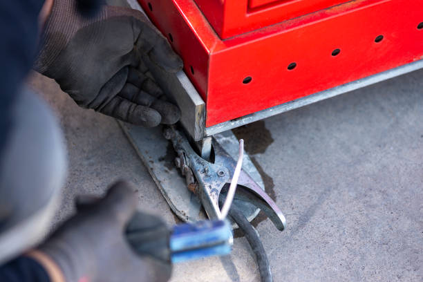 Welder Technician are welding steel with sparks flying. Metal worker / welder welding metal. He is wearing protective gloves.