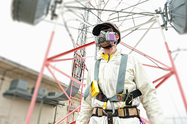 Hazardous Materials Worker in Hazard Suit with Respirator.  Radio tower painter man wearing protective safety equipment while removing lead paint from radio tower.  Captured as a 14-bit Raw file. Edited in ProPhoto RGB color space.