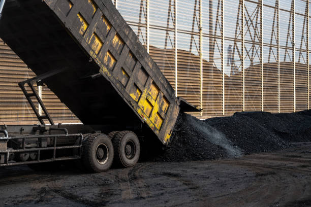 Trucks loading and unloading at large coal yard yards