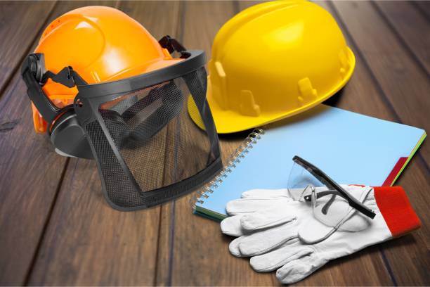 Yellow helmet with equipment on wooden background